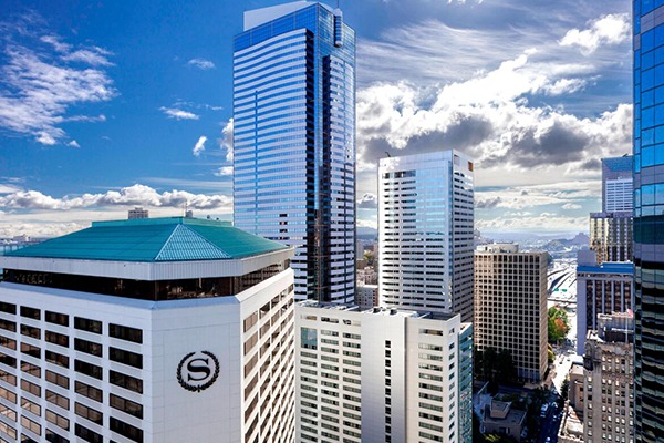 Downtown skyline featuring modern skyscrapers. Blue sky and clouds add depth, showcasing urban architecture and city life.